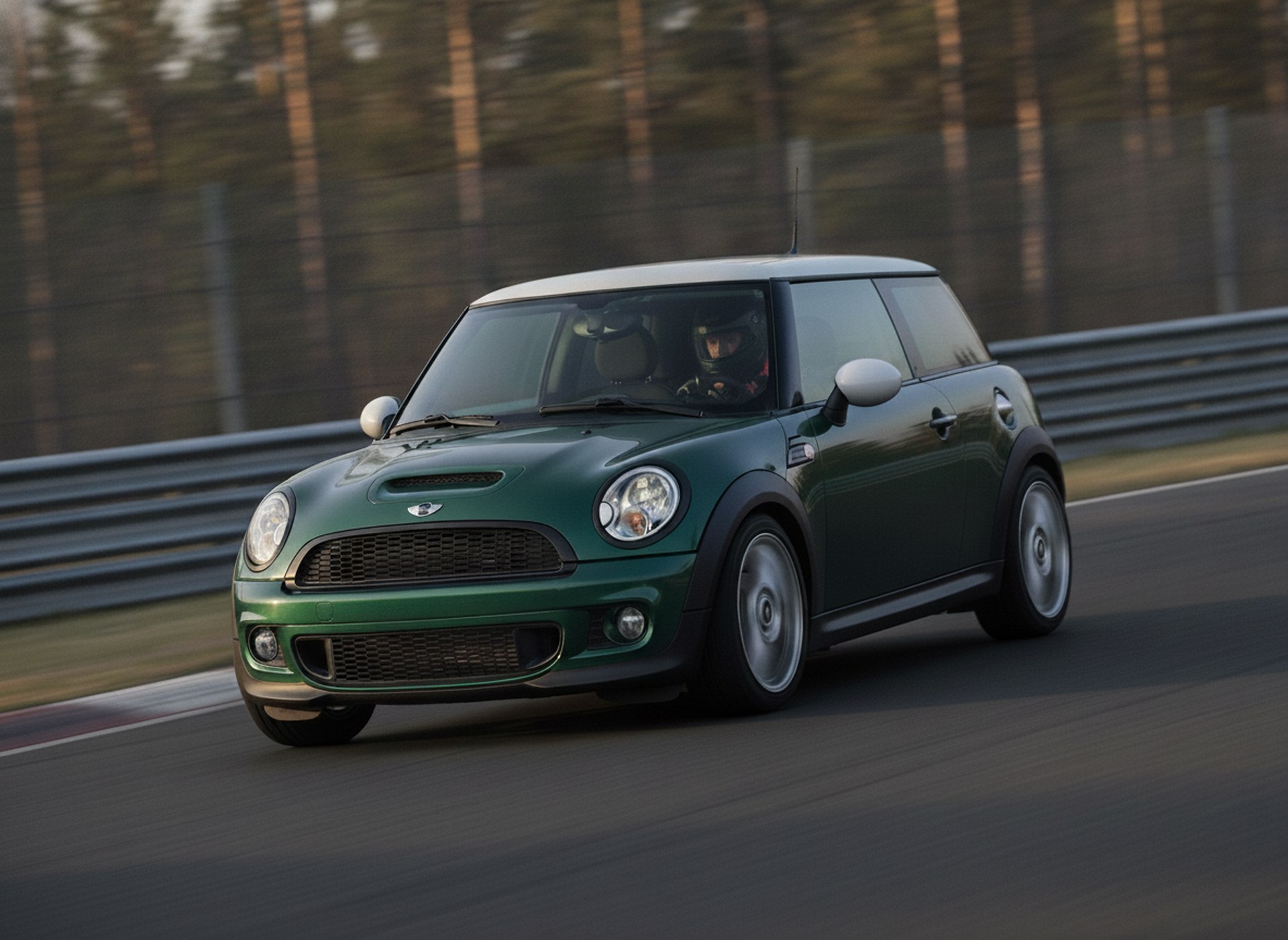 Green BMW Mini Cooper S R56 being driven hard through a corner on a race circuit, driver in a plain black helmet