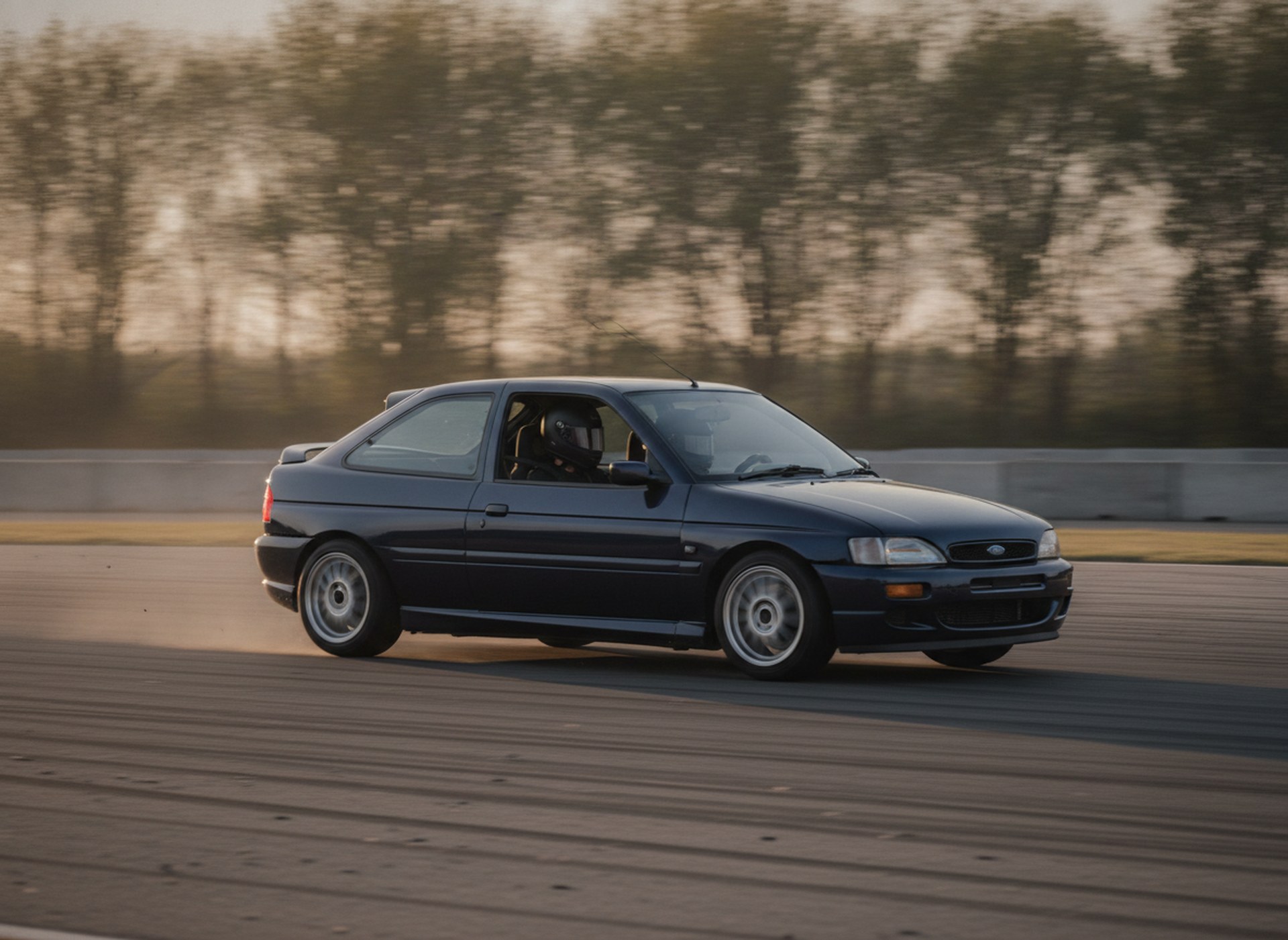 Modified Ford Escort MK6 on a race circuit, driver in a plain black helmet