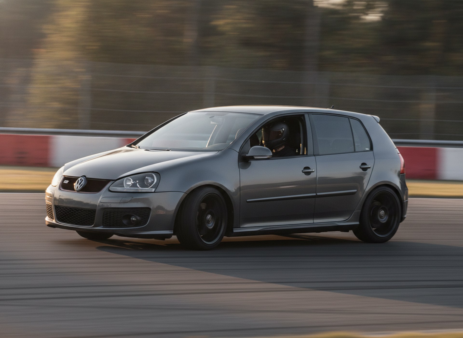 Modified Volkswagen Golf MK5 on a race circuit, driver in a plain black helmet