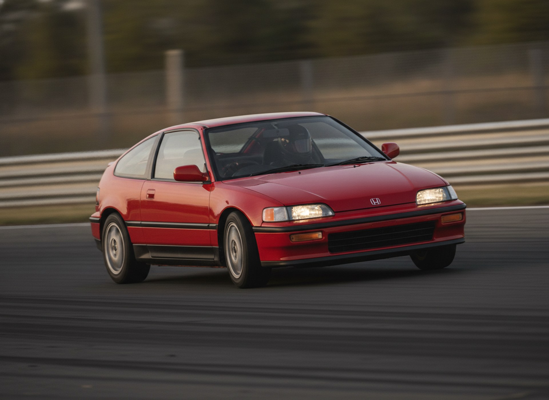 Red Honda CRX being driven hard through a corner on a race circuit