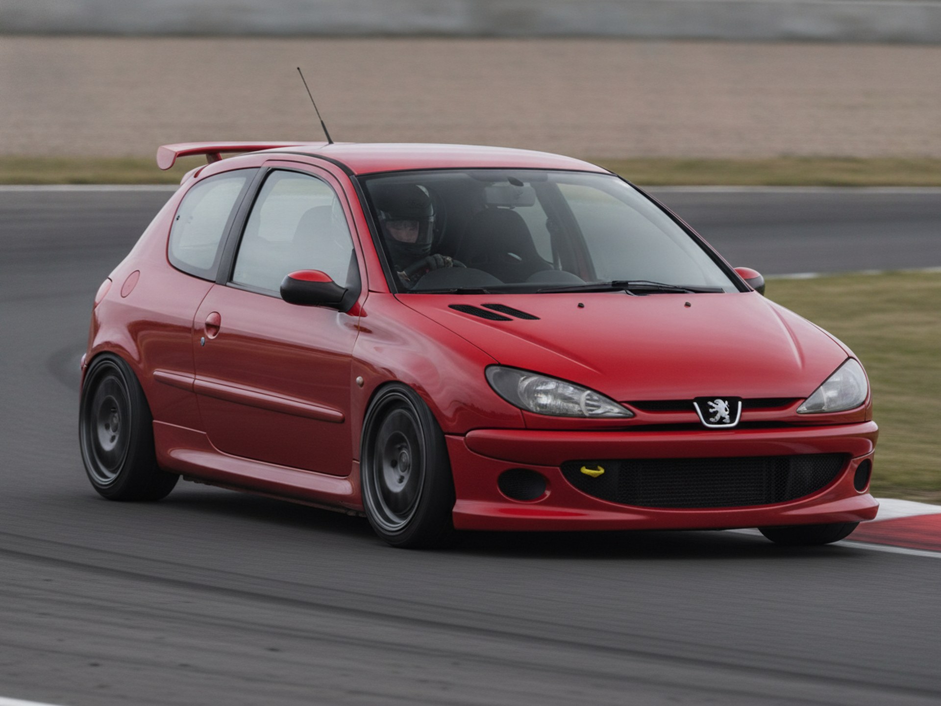 Red Peugeot 206 GTI being driven hard through a corner on a rally stage, driver in a plain black helmet